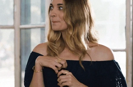 GIF of Alexis in Schitt's Creek making a movement suggesting between you and me, it's ok